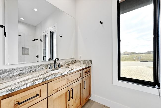 Bathroom featuring tile patterned flooring, baseboards, recessed lighting, tiled shower, and vanity | Image 28