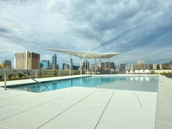 Pool with a city view and a patio | Image 19
