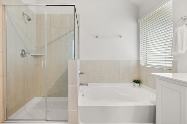 Bathroom featuring a bath, vanity, and a shower stall | Image 17