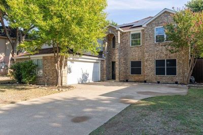 View of front facade with solar panels and a garage | Image 2