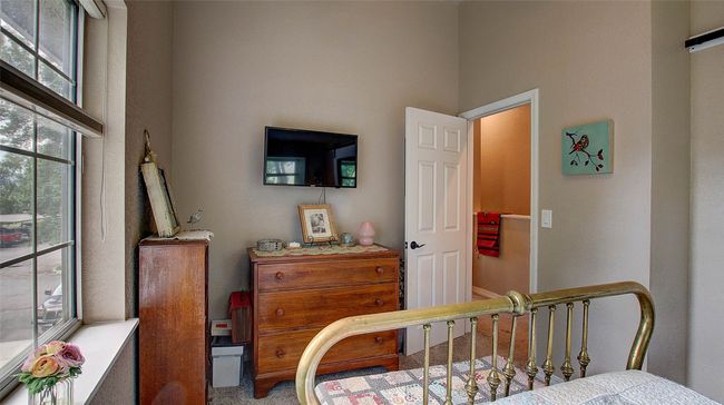 Carpeted bedroom featuring multiple windows and a towering ceiling | Image 21