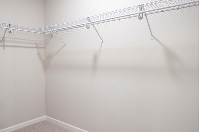 The primary suite features a spacious walk-in closet, offering plenty of room for organization and storage. Photos are from previously built home; options and features will vary. | Image 17