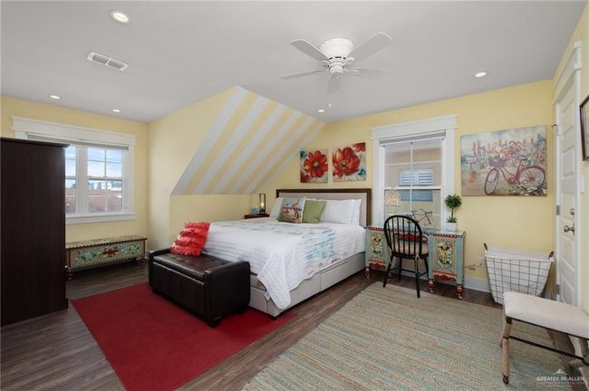 Bedroom with ceiling fan, lofted ceiling, and dark hardwood / wood-style flooring | Image 11