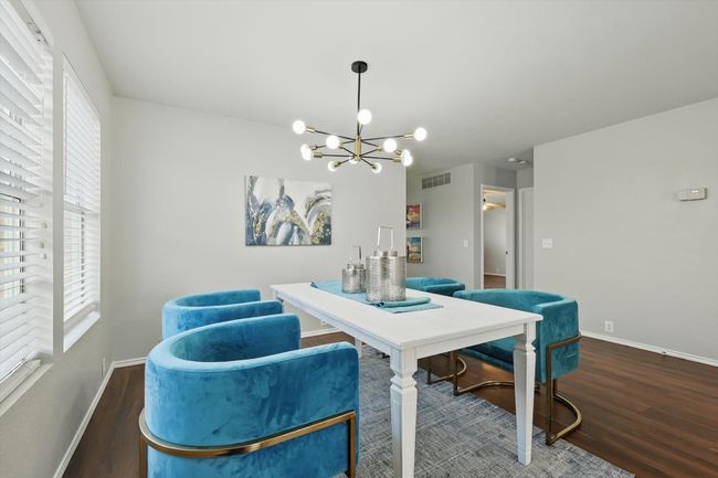 Dining area featuring a chandelier and wood finished floors | Image 10