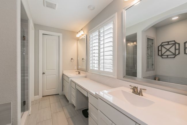 Full bathroom with double vanity and a shower with door | Image 18
