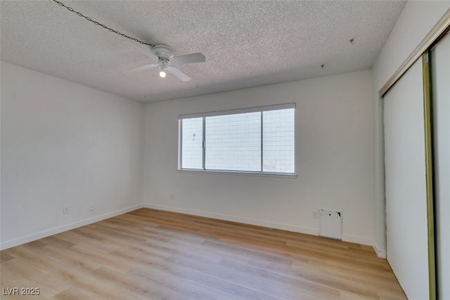 Unfurnished bedroom featuring a textured ceiling, light wood finished floors, a closet, and a ceiling fan | Image 28