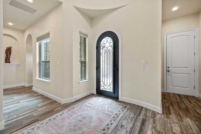 Foyer with arched walkways, wood finished floors, baseboards, and recessed lighting | Image 5