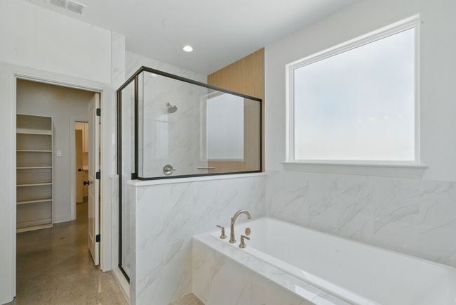 Bathroom with a marble finish shower, a bath, and recessed lighting | Image 13