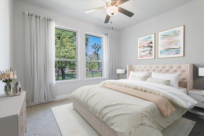 Bedroom with light colored carpet, multiple windows, and ceiling fan | Image 18
