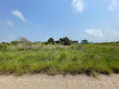 Front view of lot from Nautilus S. The property has approximately 52 feet of frontage along Nautilus S and approximately 50 feet overlooking the canal across at the back of the property. Great views and direct access to the canal. | Image 1