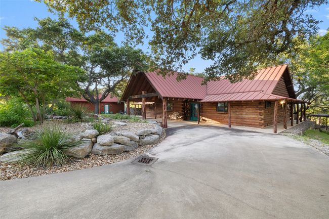 Cabin with a standing seam roof, log siding, and a metal roof | Image 18