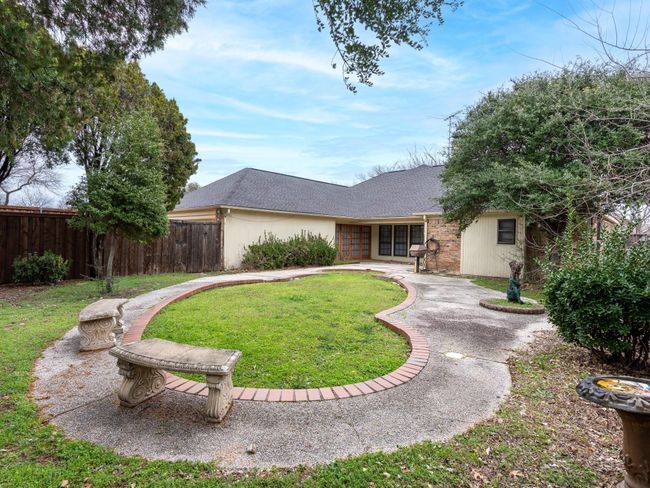 View of front of house with roof with shingles, fence, a front yard, brick siding, and a patio area | Image 27