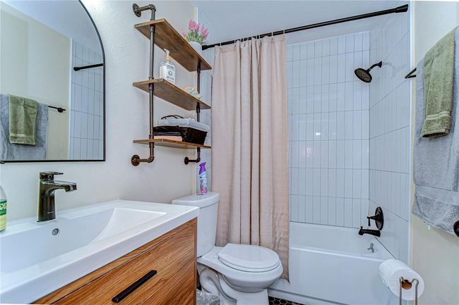 Renovated bathroom featuring a shower/tub combo | Image 8