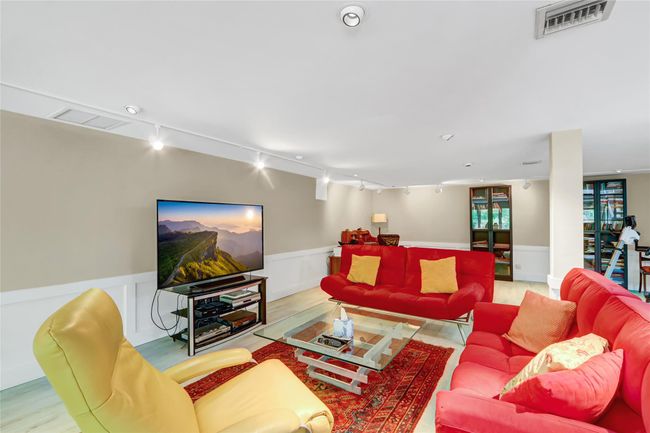 Living area featuring visible vents, a wainscoted wall, rail lighting, and a decorative wall | Image 27