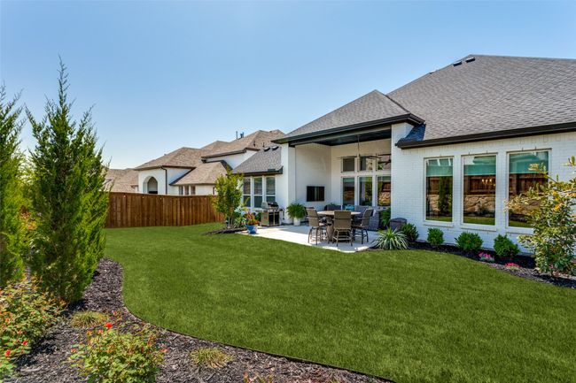 Rear view of house featuring roof with shingles, a patio, and brick siding | Image 38
