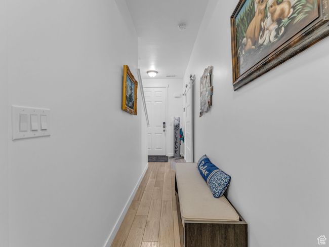 Corridor featuring baseboards and light wood-type flooring | Image 17