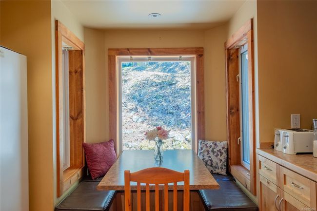 Cozy eating nook with benches and surrounded by windows | Image 16