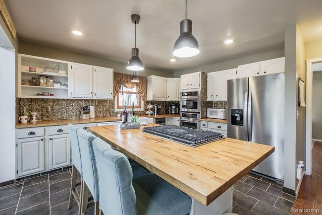 Large kitchen with huge island | Image 6