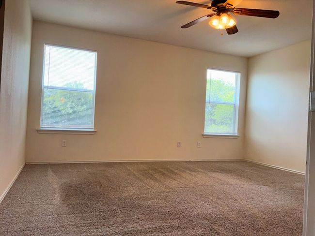 Primary bedroom featuring ceiling fan and baseboards | Image 17