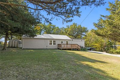 Front view of house featuring a shed, a yard, and a wooden deck | Image 3