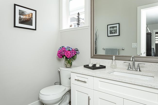 Bathroom featuring baseboards, toilet, and vanity | Image 11