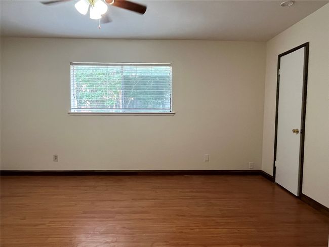 Unfurnished room with light wood-style floors, a ceiling fan, and baseboards | Image 5