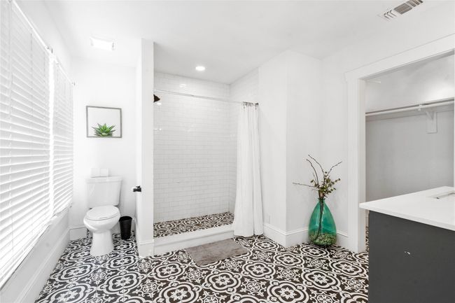 Full bath featuring a closet, a tile shower, vanity, tile patterned flooring, and recessed lighting | Image 16
