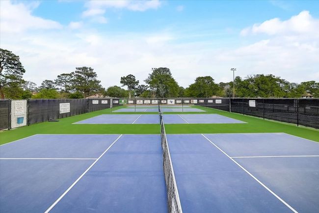 View of tennis court featuring fence and community basketball court | Image 15