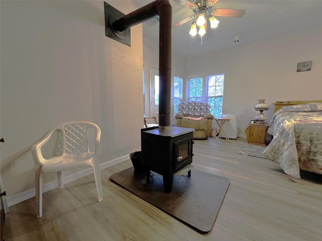 This wood burning stove warms the primary bedroom on chilly nights. | Image 32
