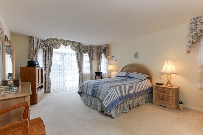 Bedroom with light carpet, access to outside, and baseboards | Image 25