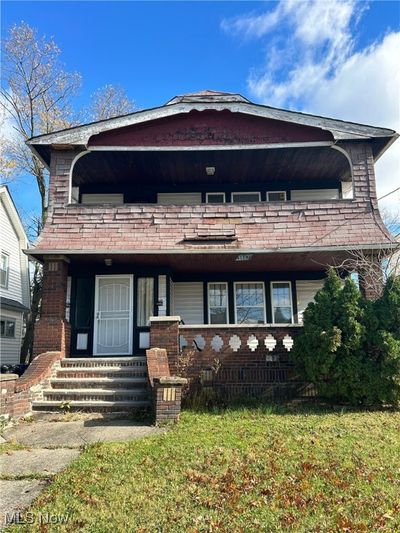 View of front of house with covered porch and a front yard | Image 1