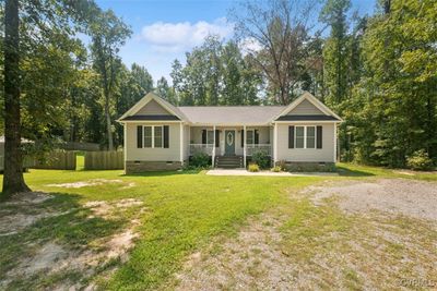 Ranch-style house featuring a front lawn and a porch | Image 1