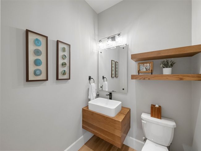 Half bathroom featuring vanity and wood finished floors | Image 20