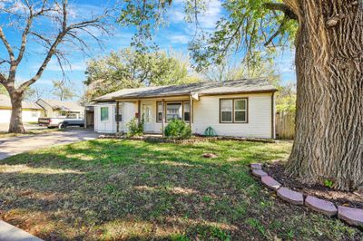 Single story home with a front lawn and a porch | Image 3