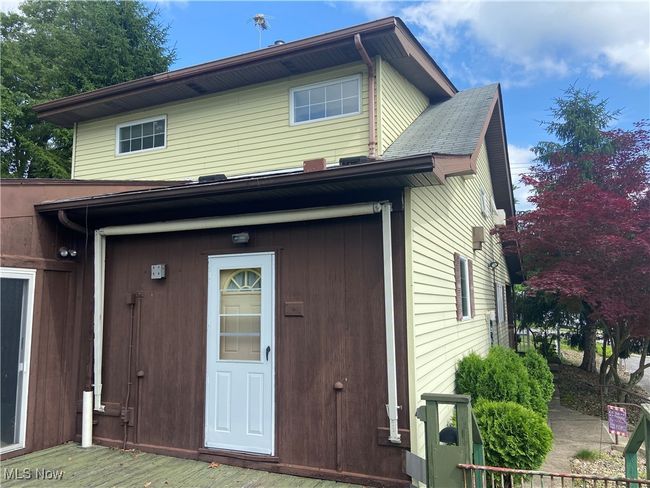 Door to room ideal for 1st floor laundry. Family room slider to the left. | Image 17