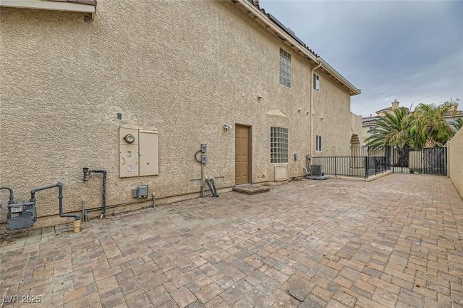 Rear view of house with stucco siding and a patio | Image 48