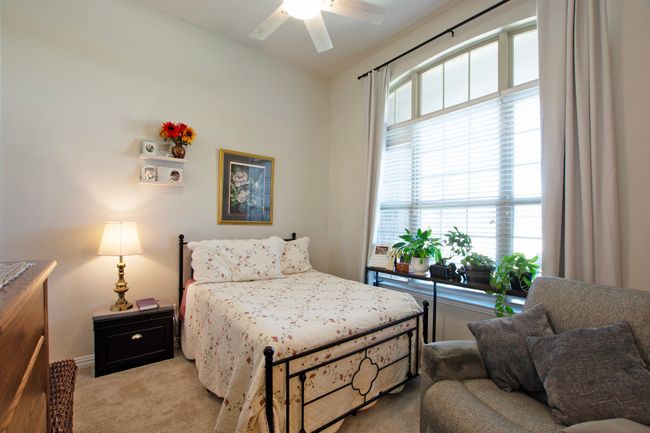 Bedroom with light colored carpet and ceiling fan | Image 34