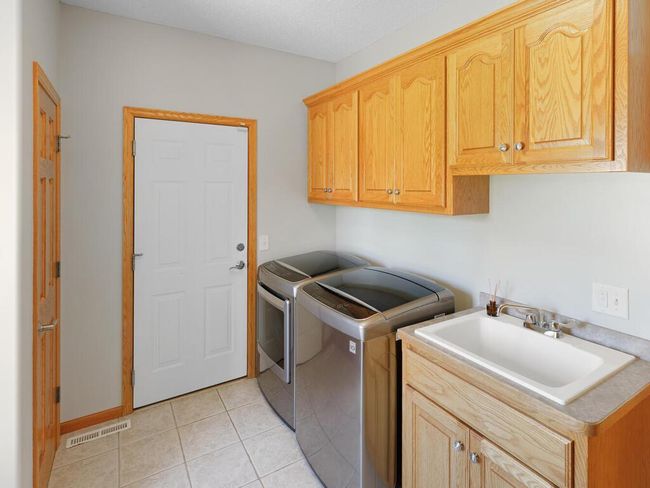 Main Level Laundry with sink and built in cabinets - 25259 Galaxy Ave Wyoming MN 55092 USA-070-016-071-MLS_Size.jpg | Image 48