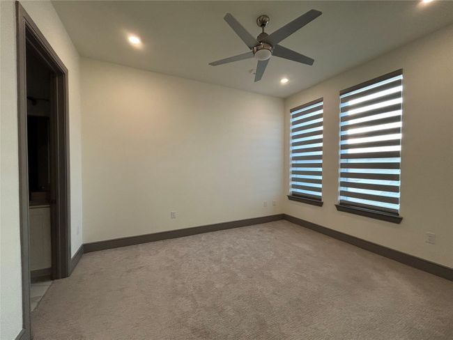 Carpeted spare room featuring ceiling fan | Image 19