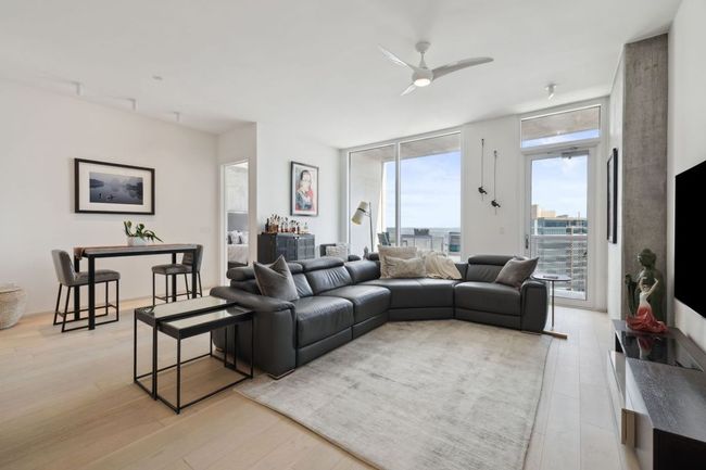 Living room featuring a ceiling fan, light wood-type flooring, and floor to ceiling windows | Image 12