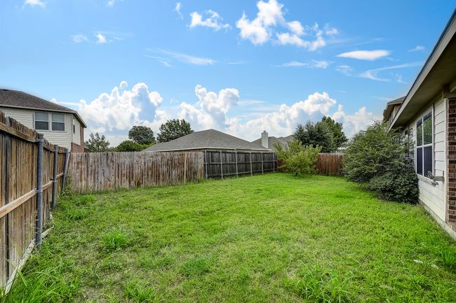 View of fenced backyard | Image 18