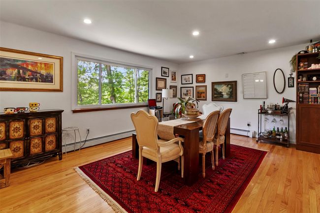 Dining room featuring a baseboard heating unit, light wood finished floors, and recessed lighting | Image 6