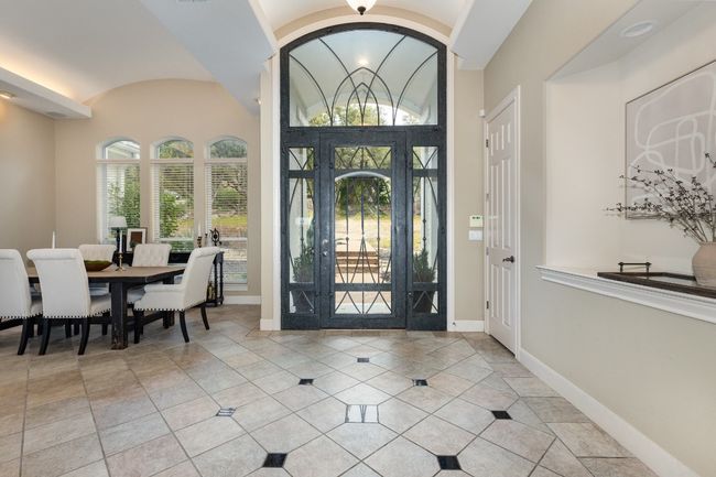 Metal door and billiards area off the entry currently used as a dining area. | Image 4