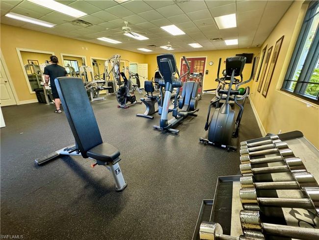 Gym with a drop ceiling, visible vents, a ceiling fan, and baseboards | Image 38