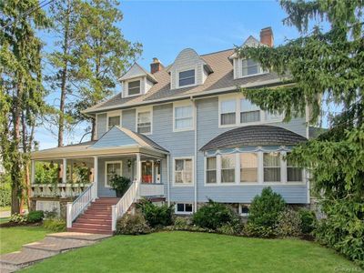 View of front facade featuring a porch and a front lawn | Image 1