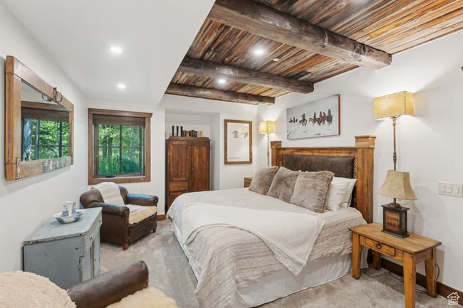Bedroom with light carpet, recessed lighting, and a wood ceiling with exposed beams | Image 41