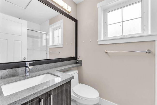 Full bathroom featuring a shower with shower door and vanity | Image 21