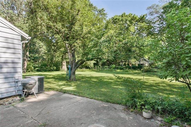 View of grassy yard with a patio | Image 5