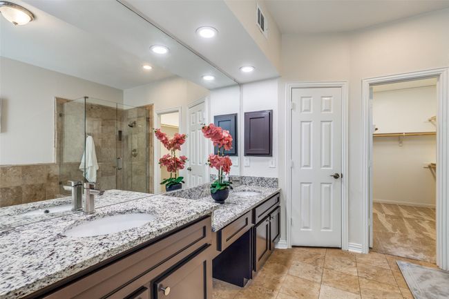 Bathroom featuring a shower stall, double vanity, a spacious closet, recessed lighting, and baseboards | Image 22