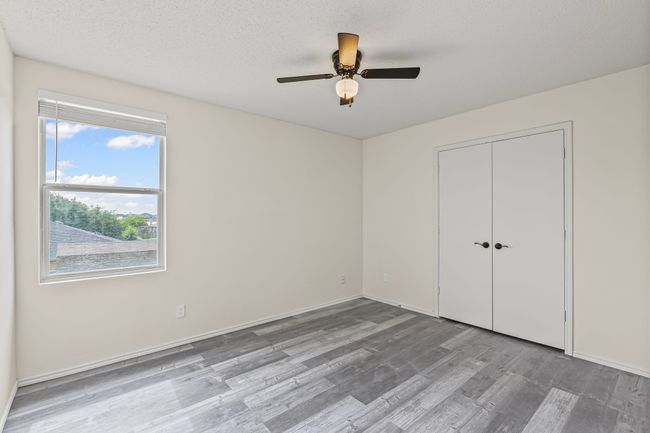 Unfurnished bedroom featuring wood finished floors, a closet, and ceiling fan | Image 19